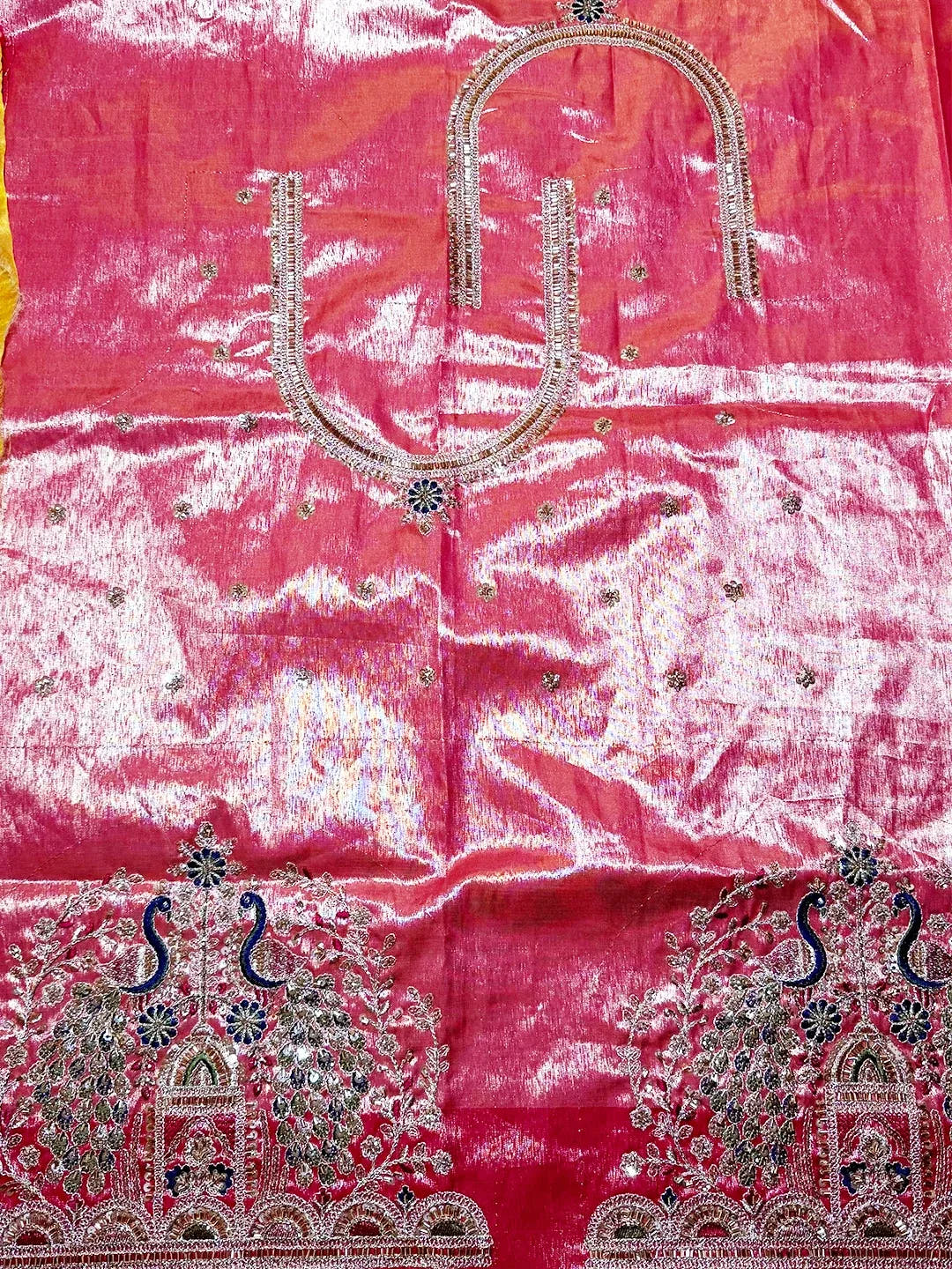 Aqua organza tissue Paithani-style minakari saree, unstitched pink blouse piece laid flat with zari neckline