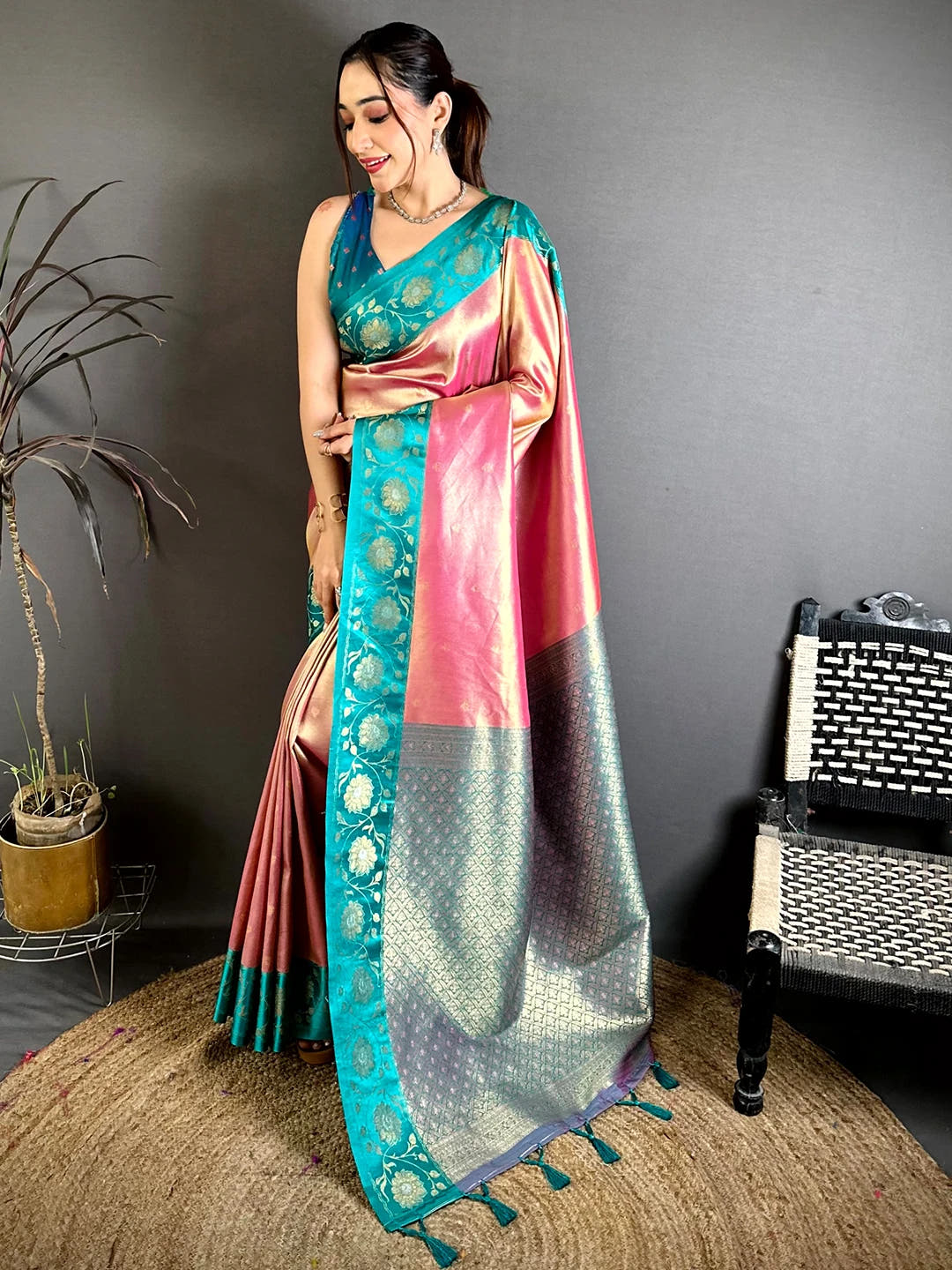 Pink soft tissue zari buti saree, full front drape on model with teal border and pallu tassels