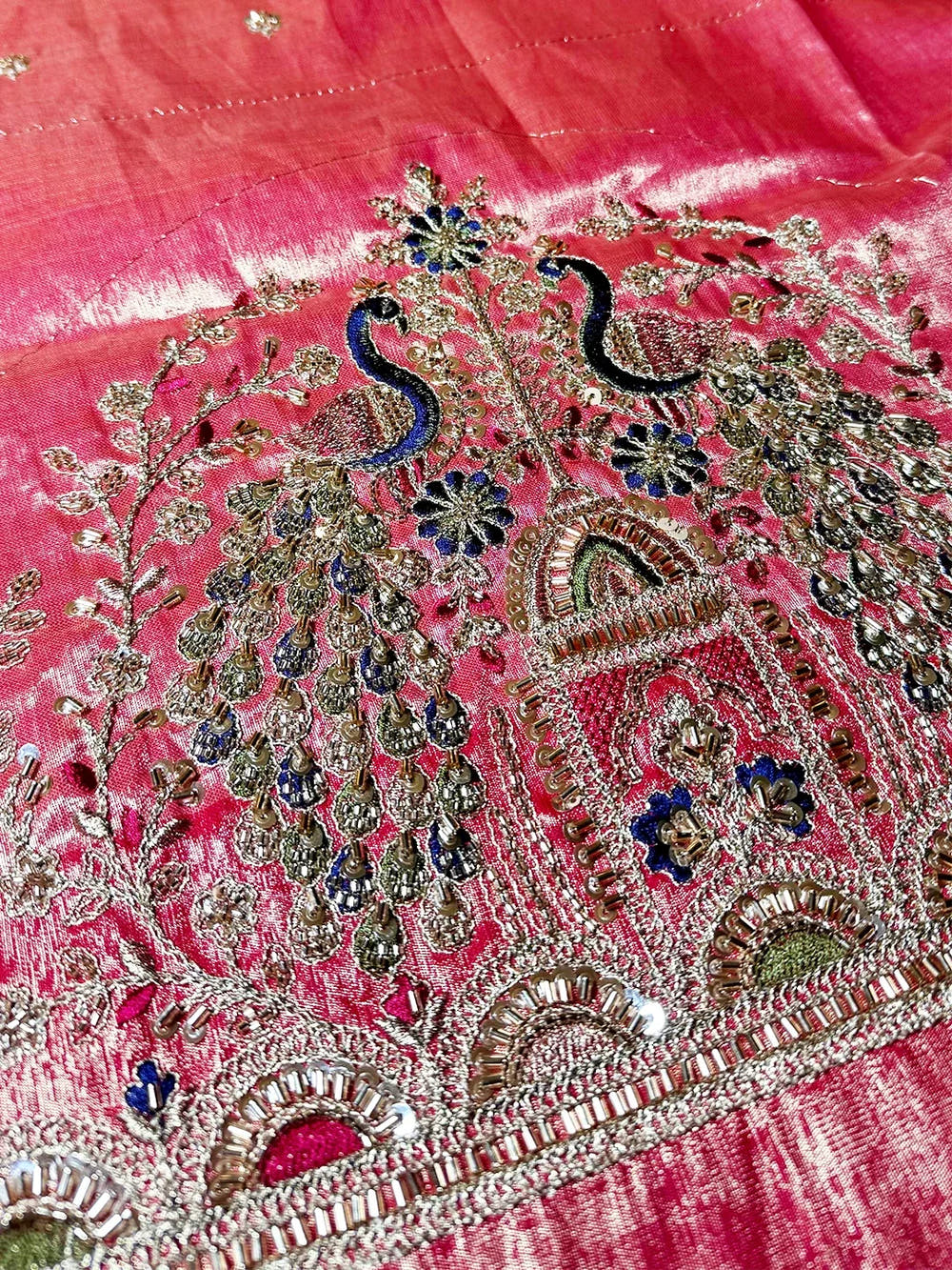 Cream organza tissue Paithani-style saree, close-up of blouse hem peacock embroidery with sequins and beads