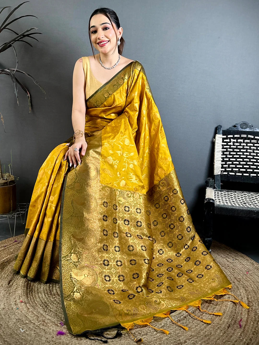Mustard yellow soft silk zari-style jaal saree, pallu draped over the shoulder with tassels at the end
