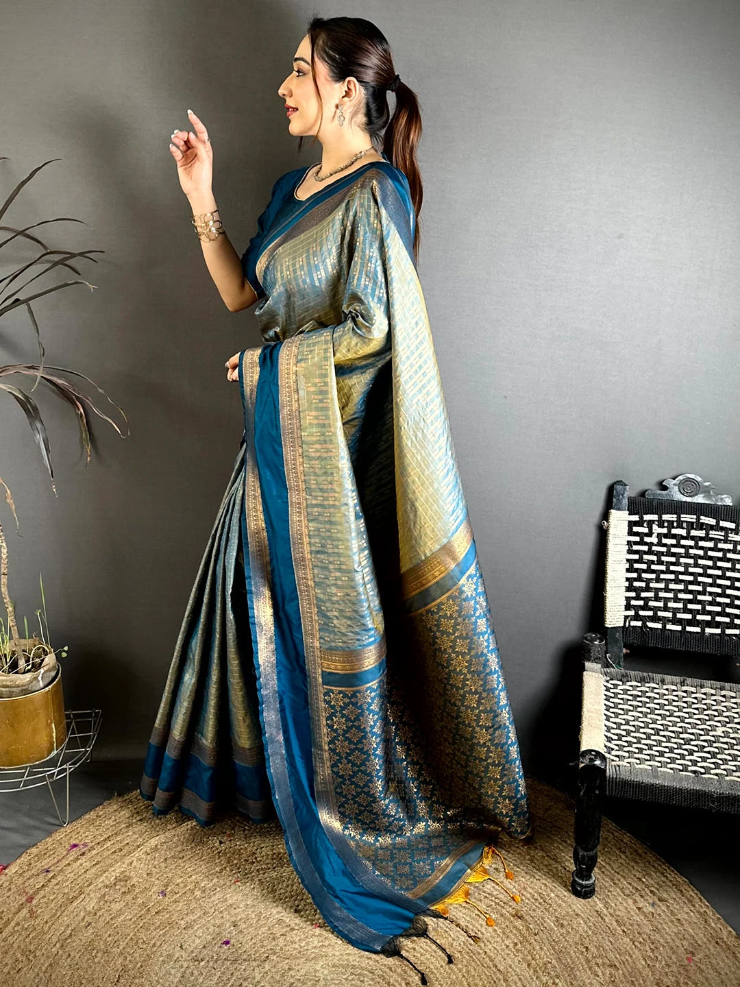 Teal Soft Silk Gold Checked Butta Saree, side view of model showing the drape and pallu fall