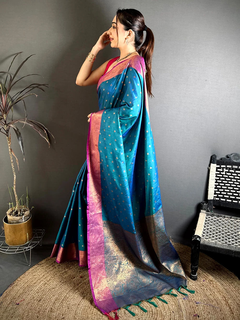 Royal Teal Raw Silk Woven Buti Saree, side view showing the magenta border and the woven pallu falling to the floor