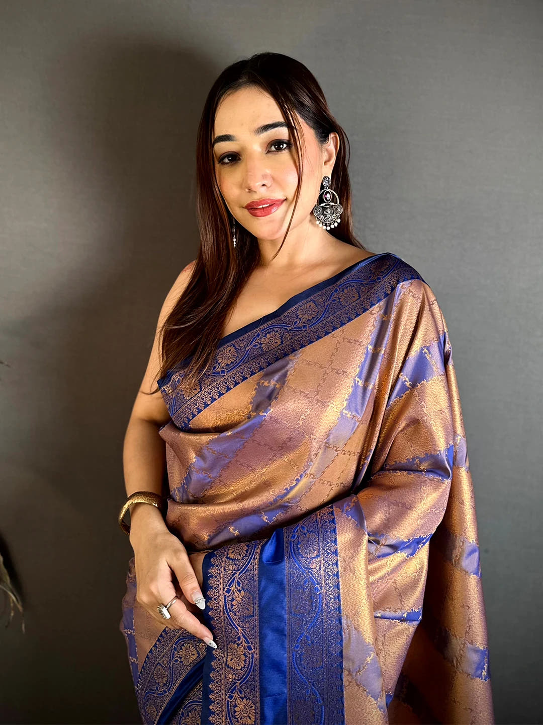 Royal Blue Kanchi Pattu lehriya zari weave saree, model in front drape with copper-gold body and blue zari border