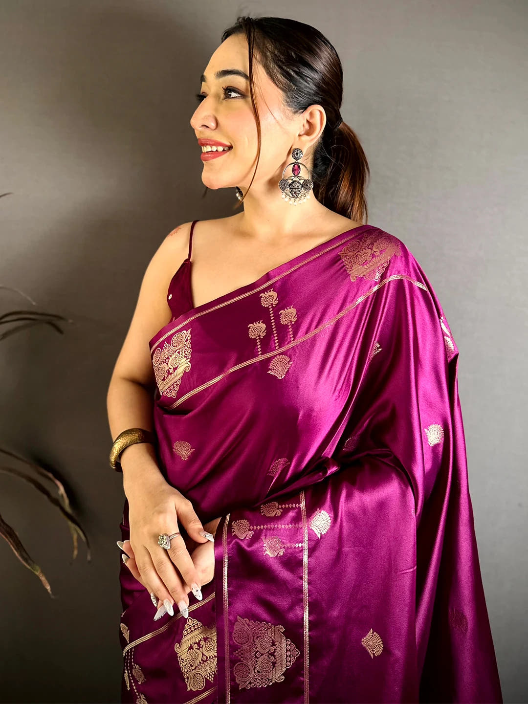 Wine Mashru Satin Silk peacock zari butta saree, model front drape with zari border over the shoulder