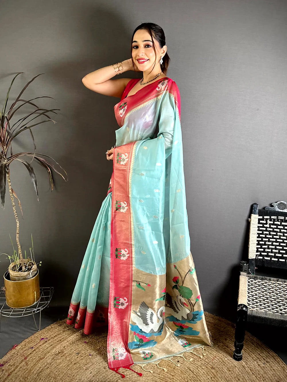 Aqua organza tissue Paithani-style minakari saree, side view of drape with rose-pink zari border and lotus motifs