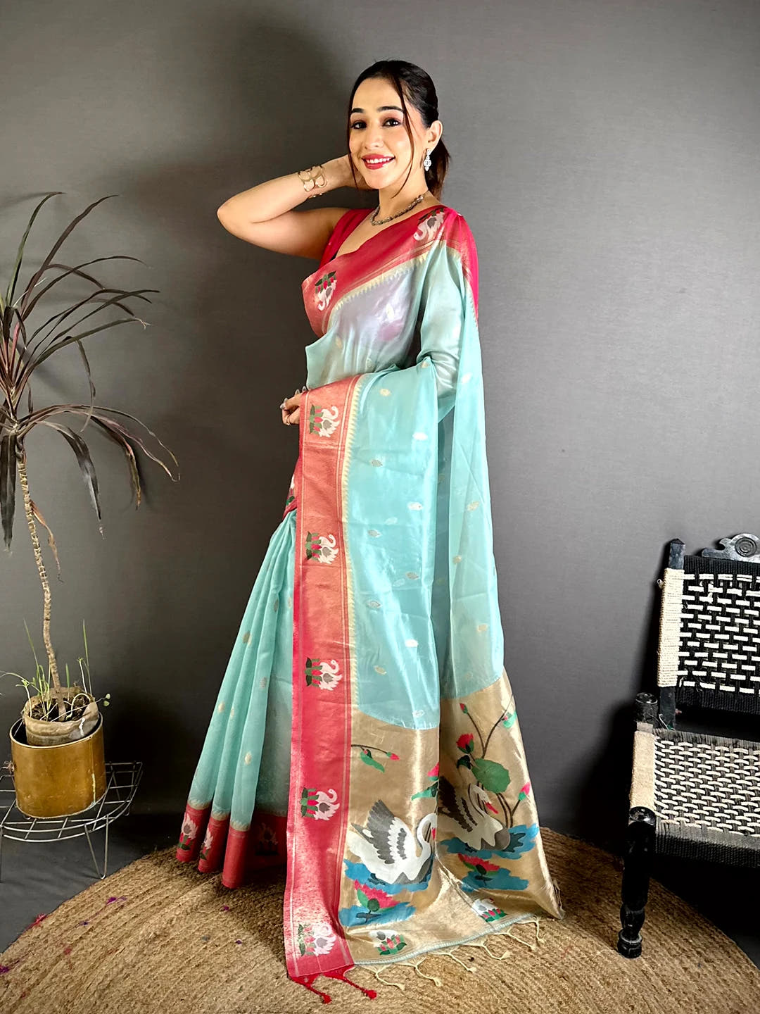 Aqua organza tissue Paithani-style minakari saree, side view of drape with rose-pink zari border and lotus motifs