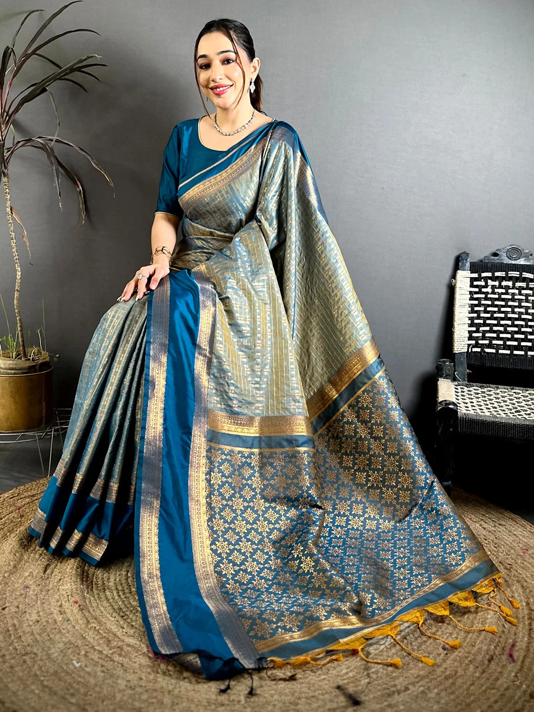 Teal Soft Silk Gold Checked Butta Saree, pallu spread on jute mat with gold geometric weave and mustard tassels