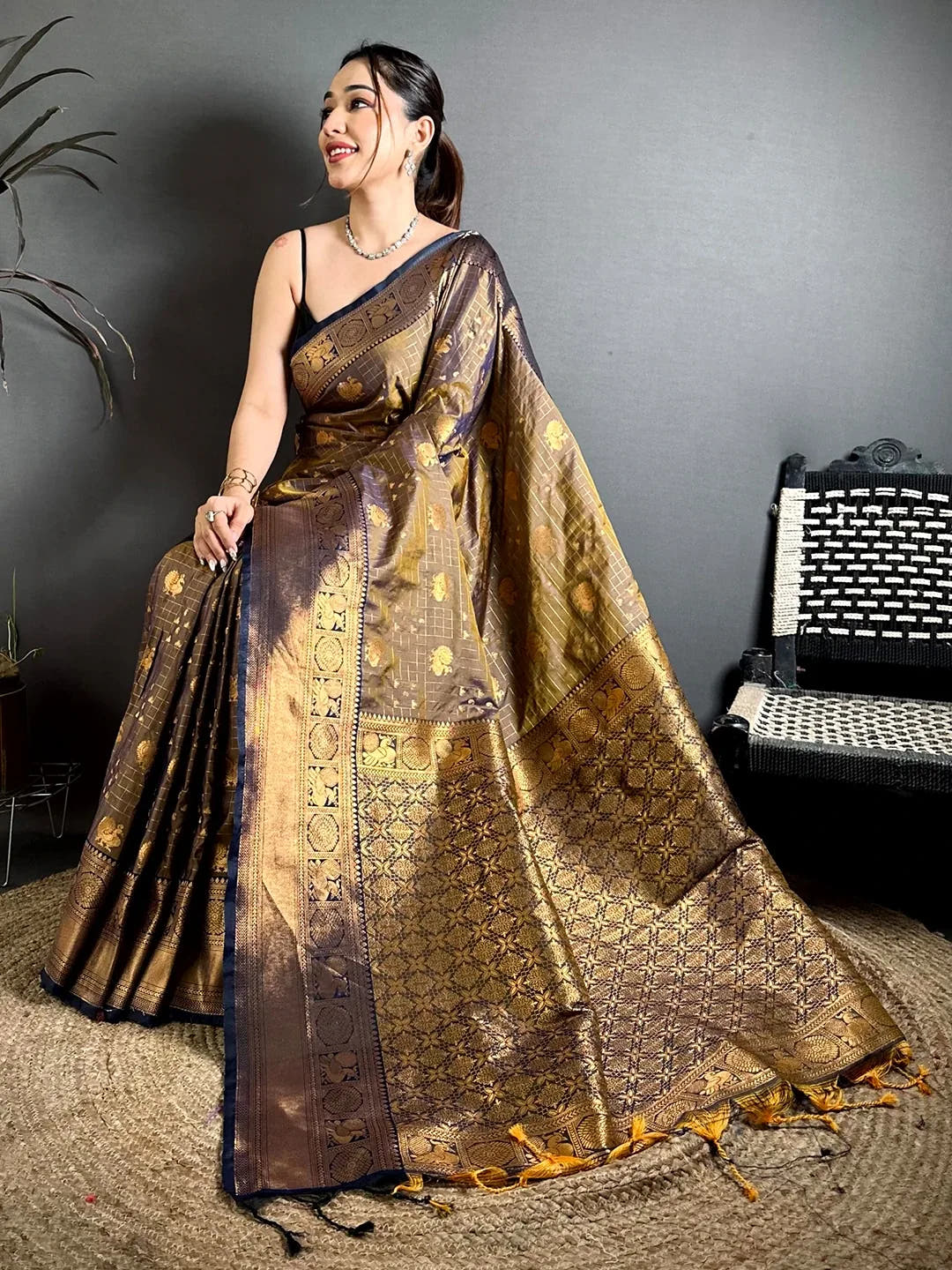 Deep bronze soft silk Kanchi-style saree, woven gold geometric pallu with tassels spread out on model