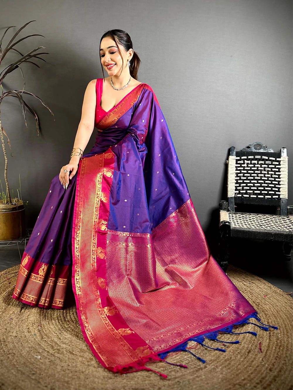 Royal Purple Soft Silk Kanchi Pattu Border Saree, seated pose showing the pink border and rich woven pallu