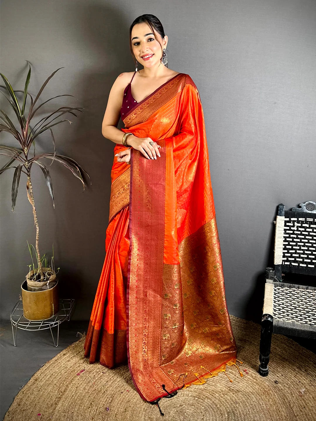 Orange Soft Silk zari check saree, front drape on a model with the full contrast pallu and maroon border