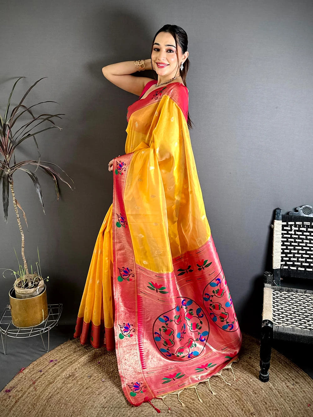 Yellow Organza Tissue Paithani-style saree, side view of a model showing the drape and the peacock and lotus pallu
