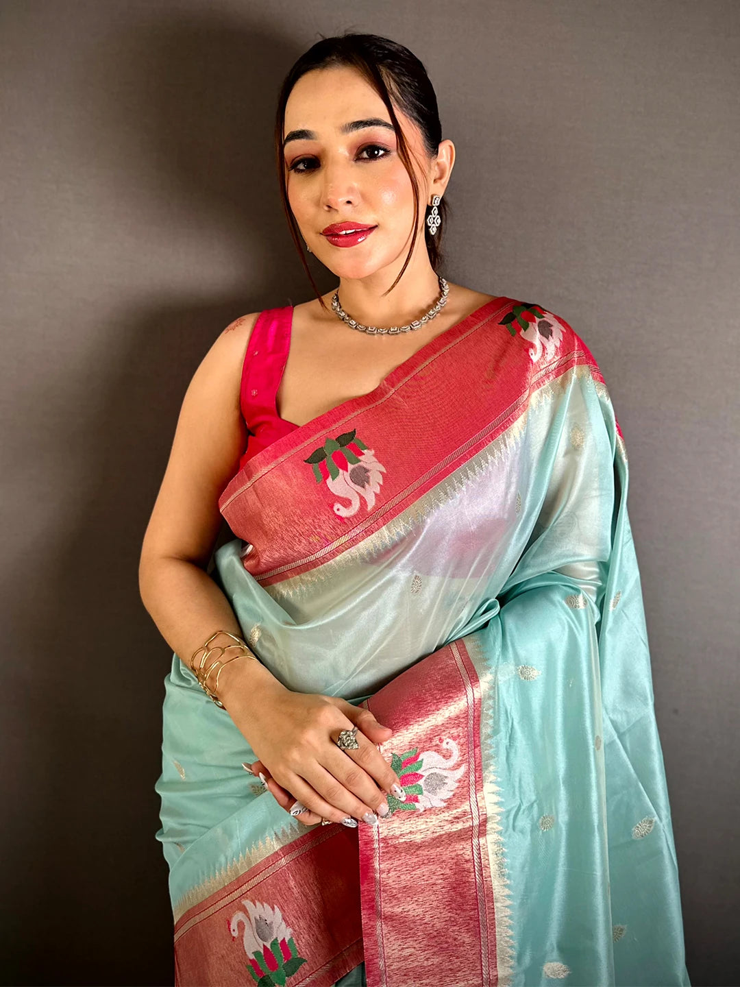 Aqua organza tissue Paithani-style minakari saree, model front drape with rose-pink swan border and pallu