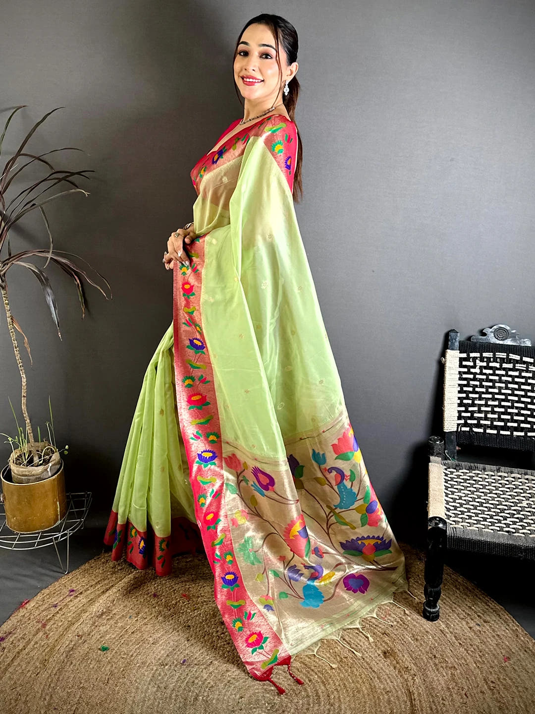 Pista green organza tissue Paithani minakari saree, side view showing the body motifs and pink border