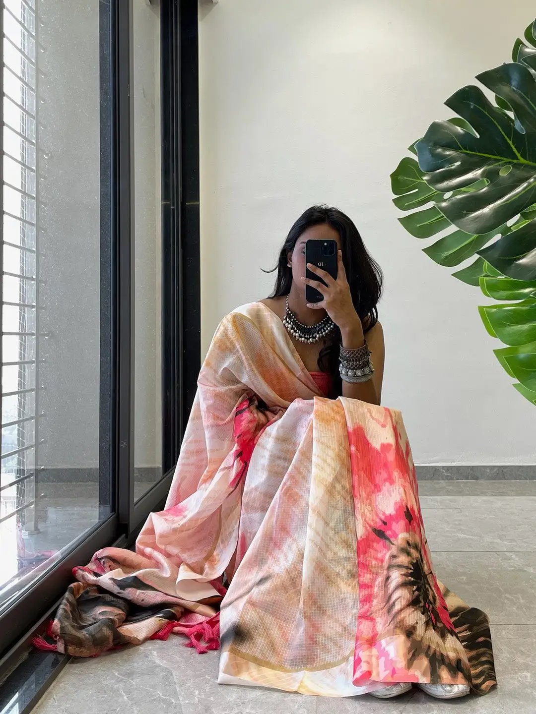 Model posing in tie dye digital printed saree with bold patterns